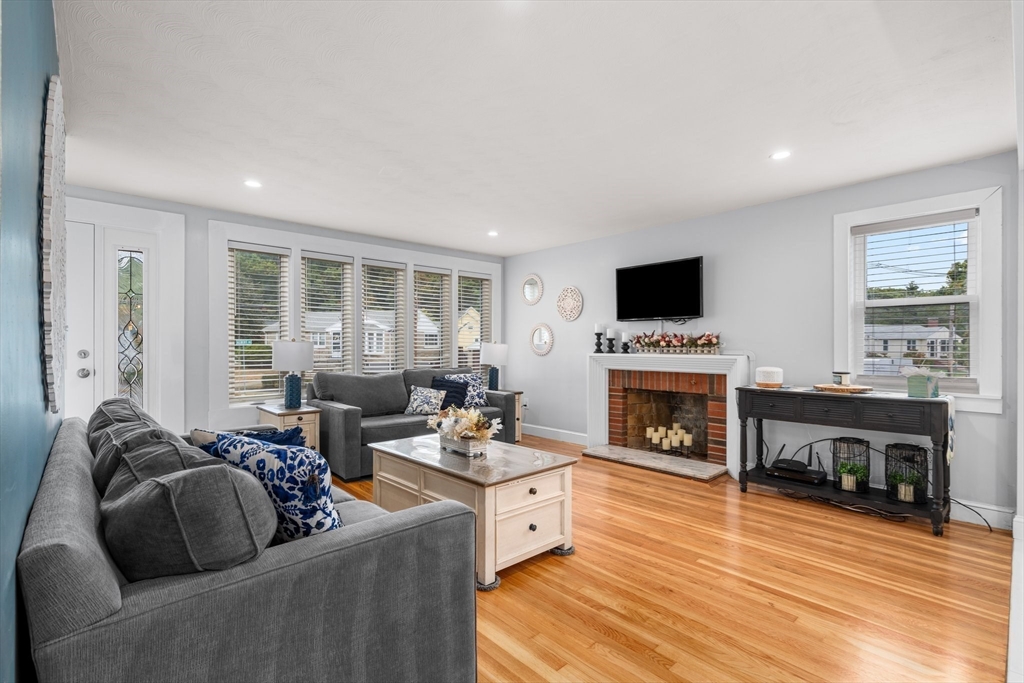 5 Albert Road Peabody, MA 01960 - Photo 3 of 39 a living room with furniture a fireplace and a flat screen tv