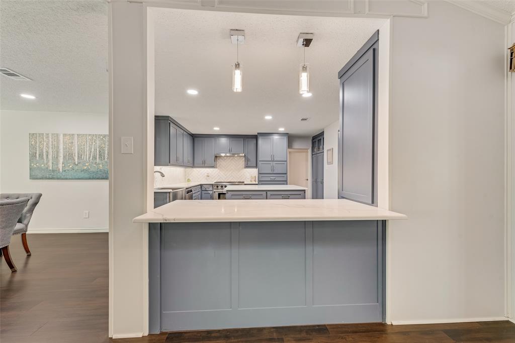 805 Crowley Road Arlington, TX 76012 - Photo 9 of 26 a kitchen with kitchen island a sink stainless steel appliances and cabinets