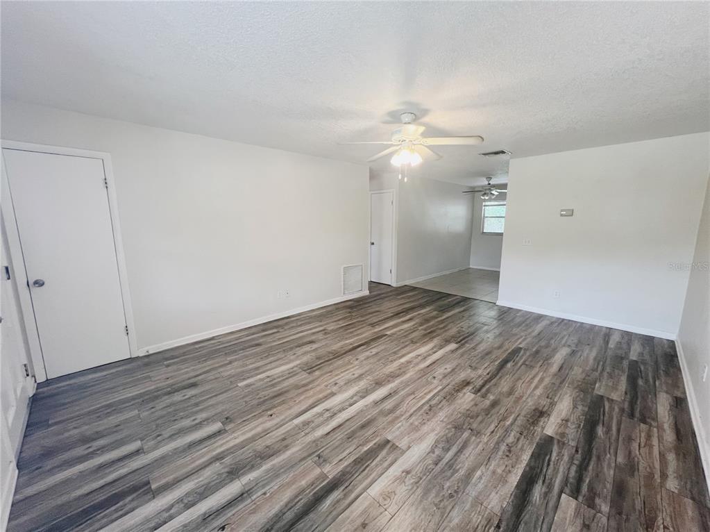 110 Willow Avenue Altamonte Springs, FL 32714 - Photo 2 of 8 an empty room with wooden floor fan and window