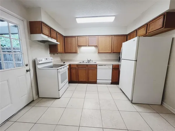 a kitchen with stainless steel appliances granite countertop a refrigerator sink and cabinets