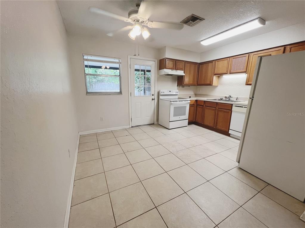 110 Willow Avenue Altamonte Springs, FL 32714 - Photo 4 of 8 a kitchen with stainless steel appliances a refrigerator sink and microwave