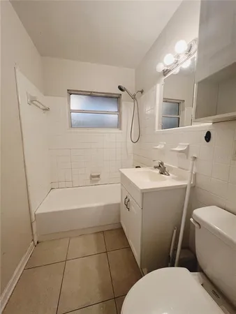 a bathroom with a sink a toilet and bathtub