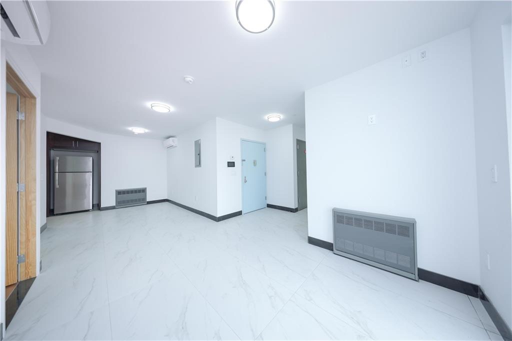 2837 West 19th Street, Unit 3A Brooklyn, NY 11224 - Photo 12 of 21 a view of an empty room with a kitchen