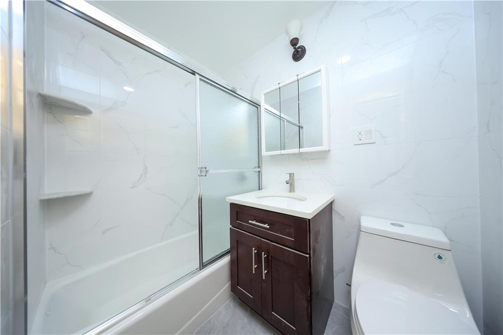 2837 West 19th Street, Unit 3A Brooklyn, NY 11224 - Photo 13 of 21 a bathroom with a sink a toilet and shower