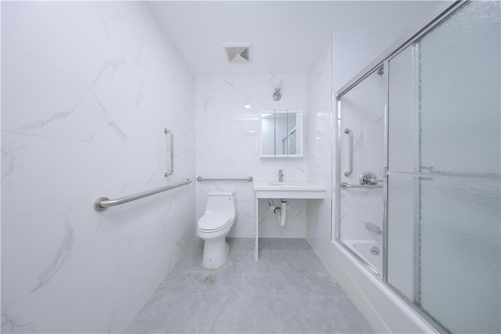 2837 West 19th Street, Unit 3A Brooklyn, NY 11224 - Photo 14 of 21 a bathroom with a sink a toilet and shower