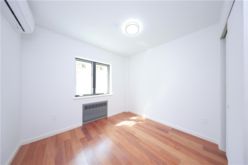 2837 West 19th Street, Unit 3A Brooklyn, NY 11224 - Photo 5 of 21 a view of empty room with wooden floor and fan