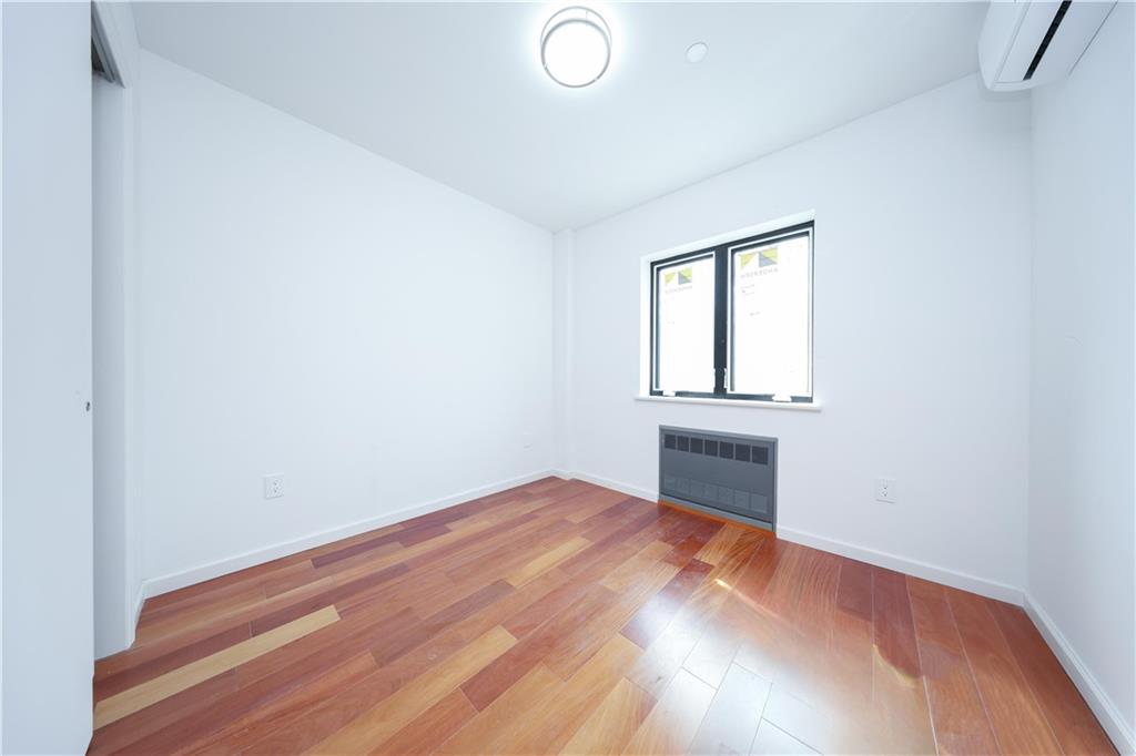 2837 West 19th Street, Unit 3A Brooklyn, NY 11224 - Photo 6 of 21 an empty room with wooden floor and windows
