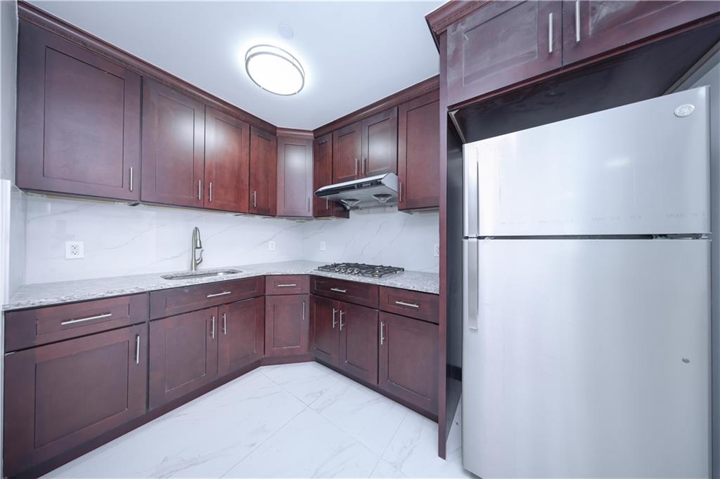 2837 West 19th Street, Unit 3A Brooklyn, NY 11224 - Photo 8 of 21 a kitchen with stainless steel appliances granite countertop a refrigerator and a sink