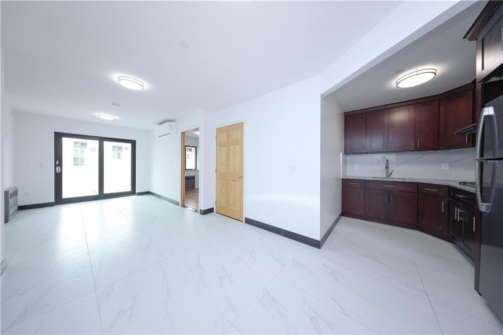 2837 West 19th Street, Unit 3A Brooklyn, NY 11224 - Photo 10 of 21 a view of a kitchen with a sink and a refrigerator