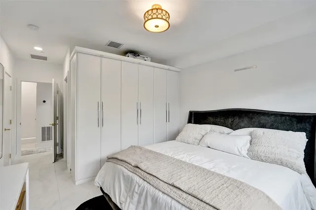 a view of a dining room with furniture and a potted plant