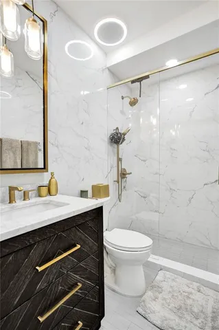 a living room with furniture and a dining table with kitchen view