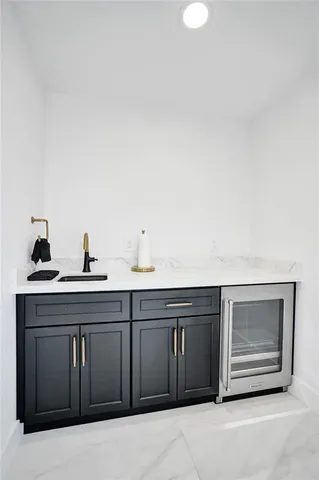 a kitchen with granite countertop stainless steel appliances and white cabinets