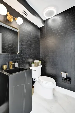 a kitchen with granite countertop white cabinets stainless steel appliances and a sink
