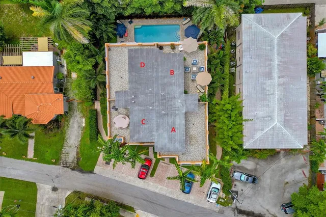 a kitchen with kitchen island granite countertop stainless steel appliances cabinets a sink and a refrigerator