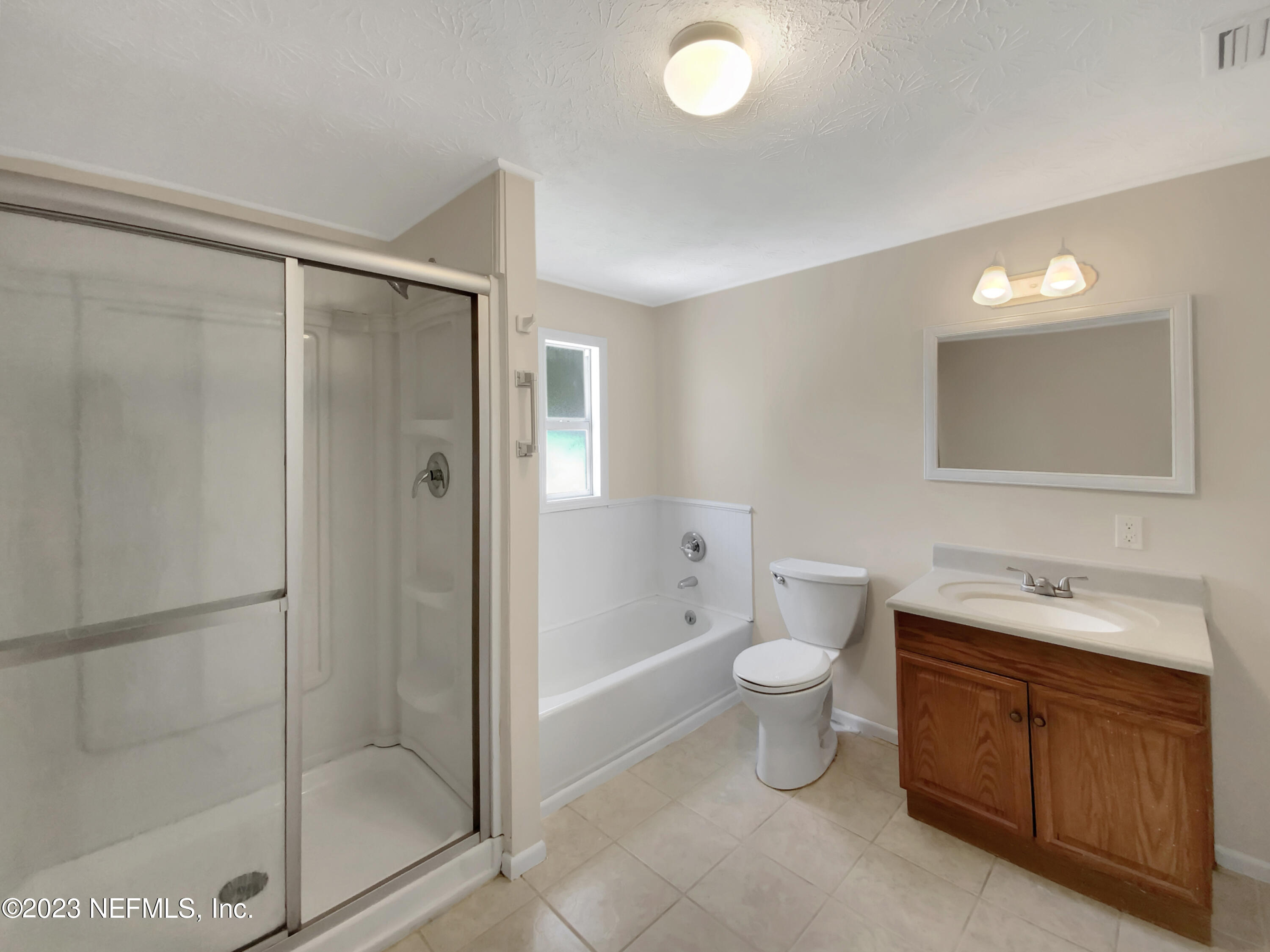 413 Sigsbee Road Orange Park, FL 32073 - Photo 12 of 18 a bathroom with a toilet sink and shower