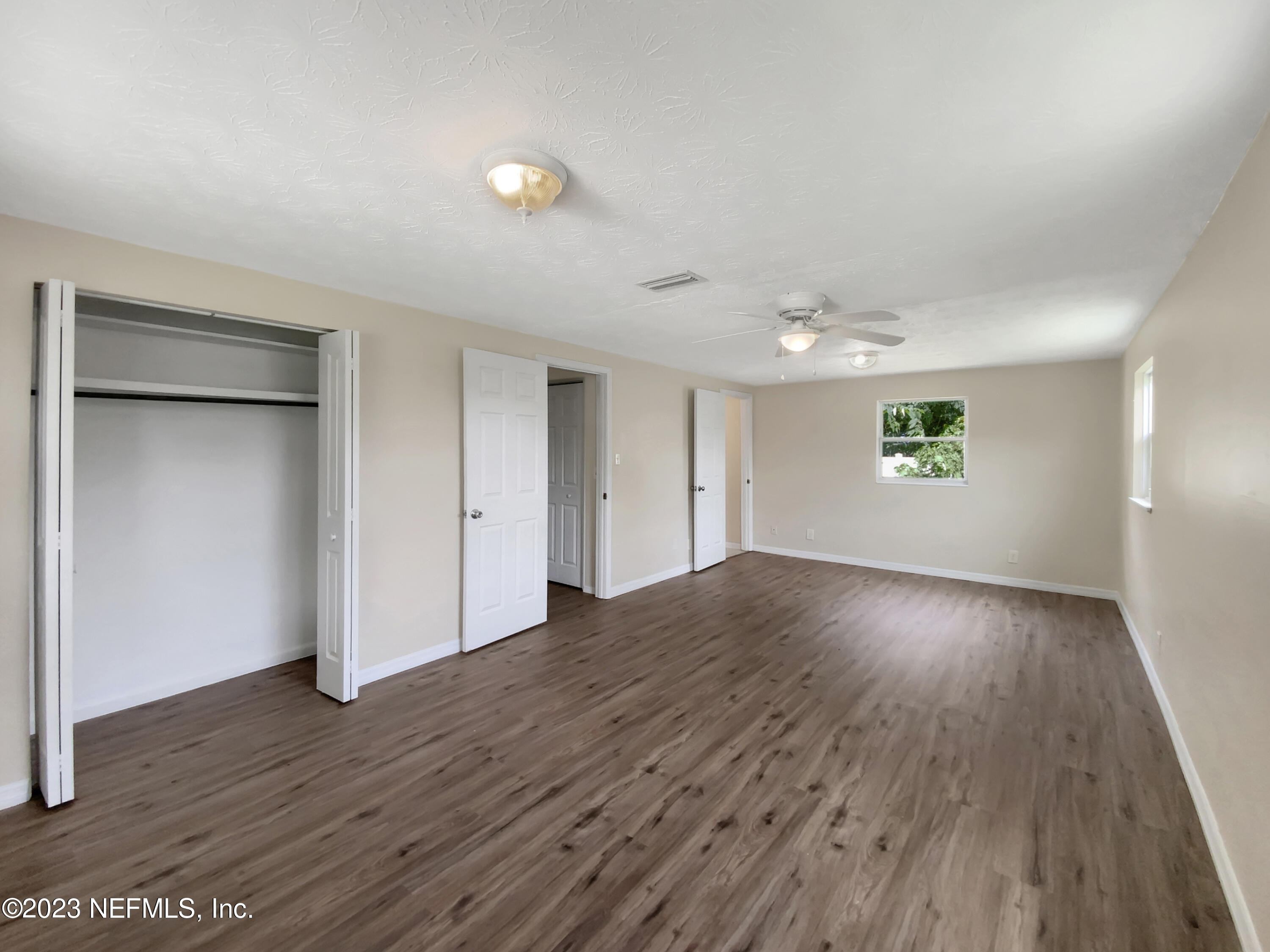 413 Sigsbee Road Orange Park, FL 32073 - Photo 3 of 18 a view of an empty room with wooden floor and a window