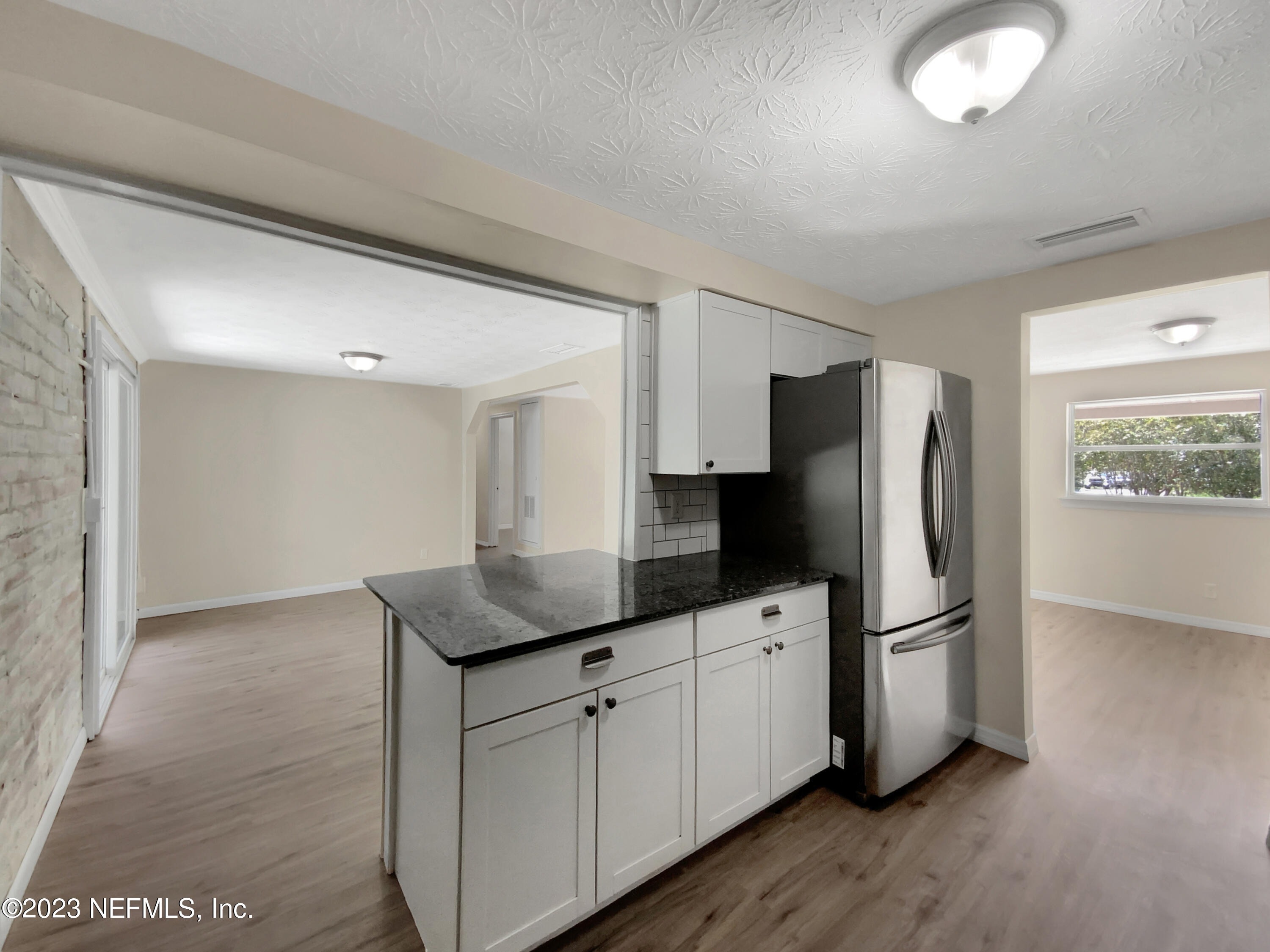 413 Sigsbee Road Orange Park, FL 32073 - Photo 8 of 18 a kitchen with stainless steel appliances granite countertop a refrigerator a sink and a stove