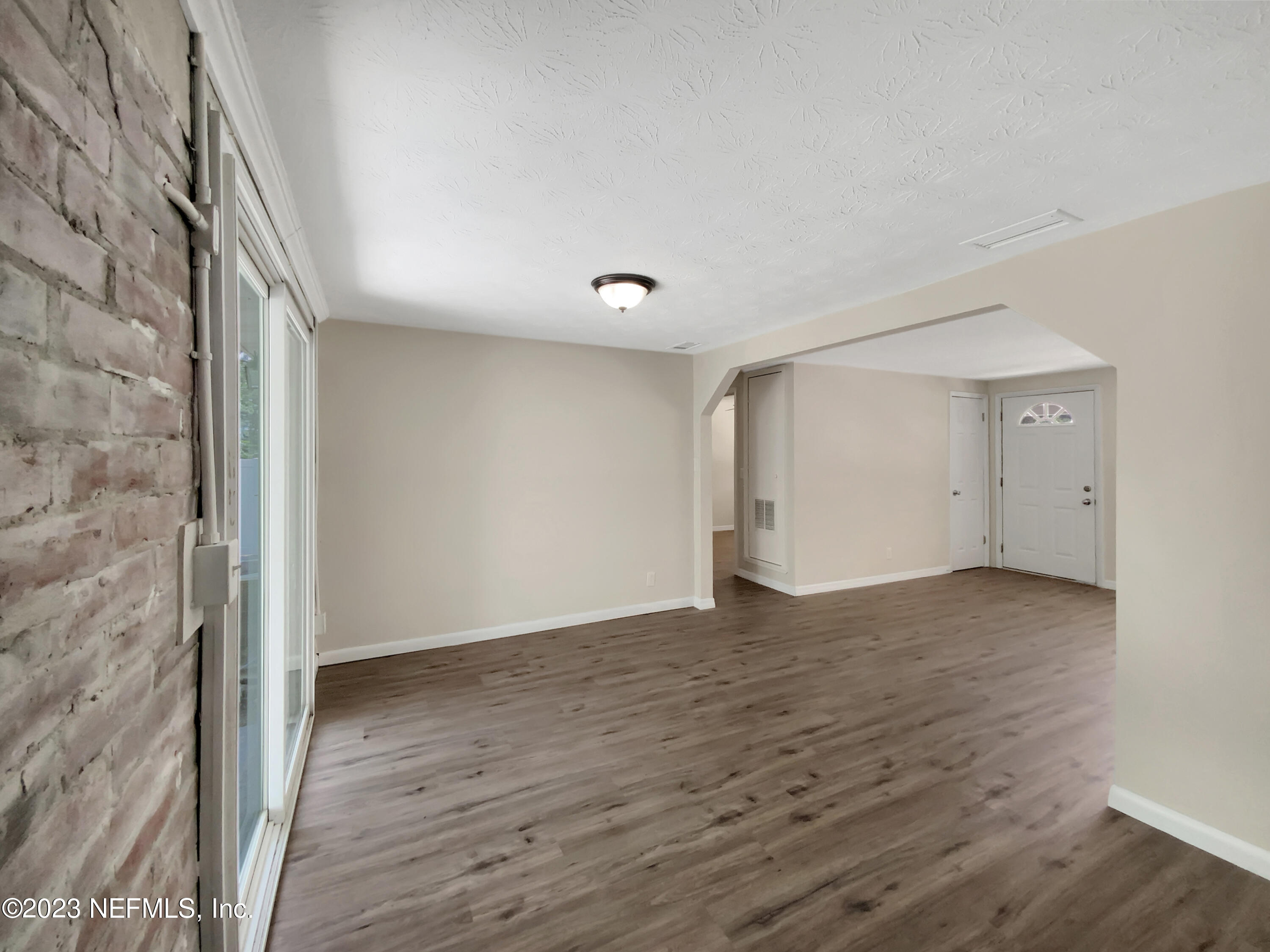 413 Sigsbee Road Orange Park, FL 32073 - Photo 9 of 18 a view of an empty room and wooden floor