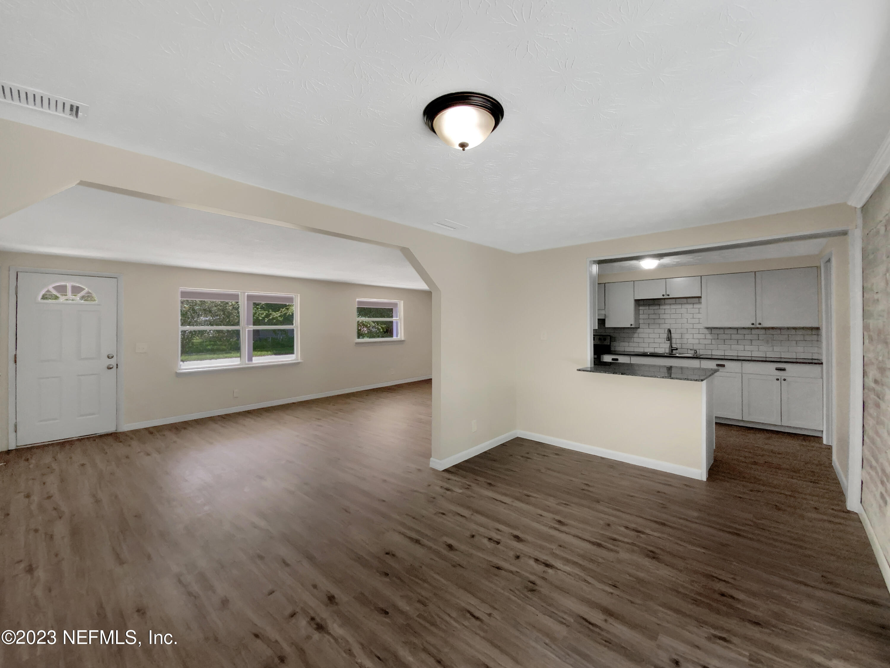 413 Sigsbee Road Orange Park, FL 32073 - Photo 10 of 18 a view of kitchen with wooden floor and windows