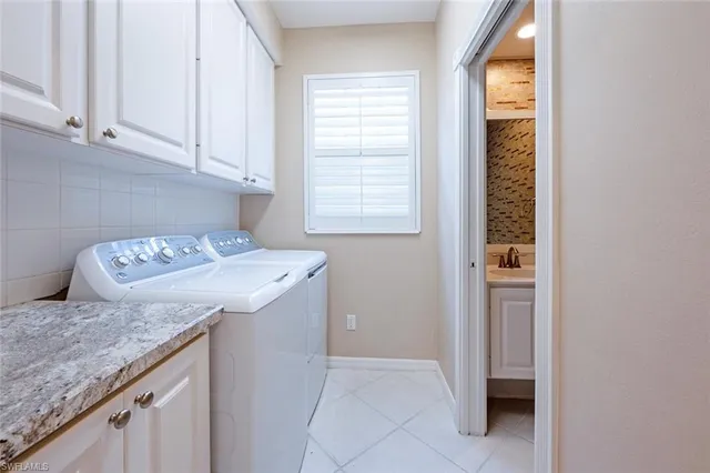 a utility room with a sink washer and dryer