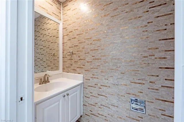 a bathroom with a sink a vanity and a shower