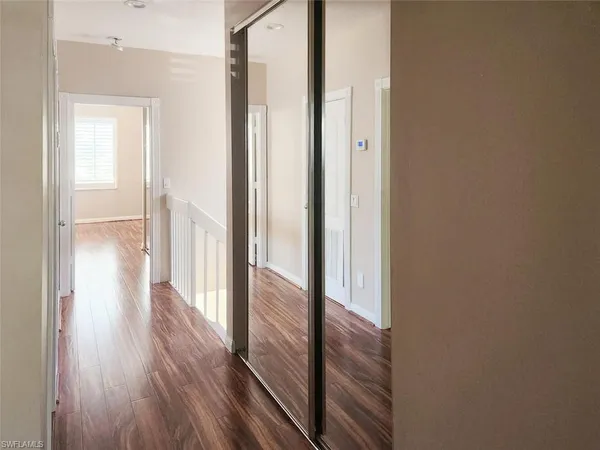 a view of a hallway with wooden floor