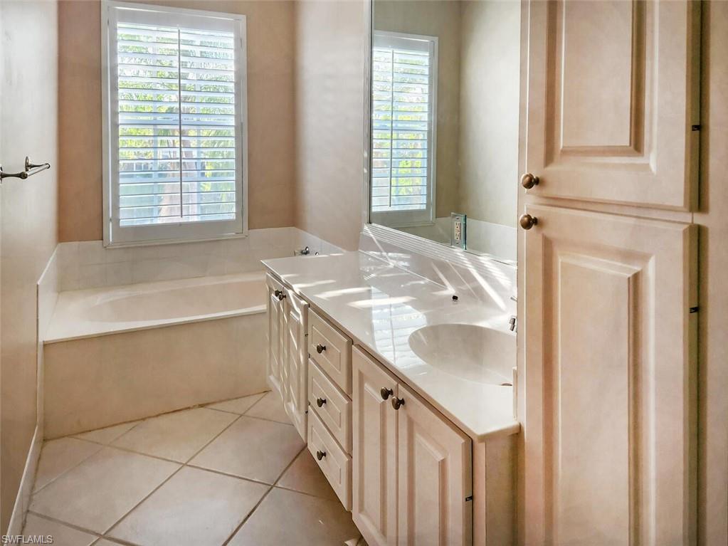 5417 Cove Circle, Unit 112 Naples, FL 34119 - Photo 18 of 37 a bathroom with a sink and a bathtub
