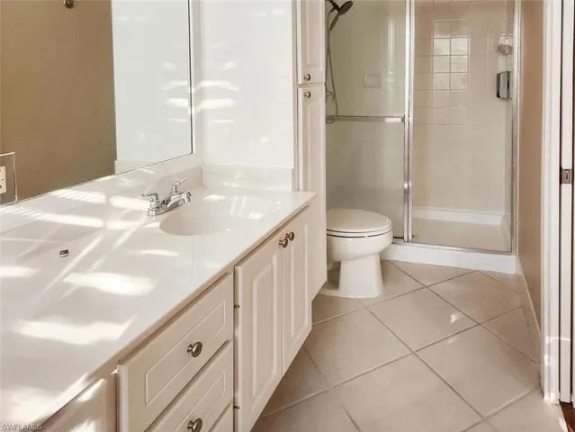 a bathroom with a double vanity sink toilet and shower