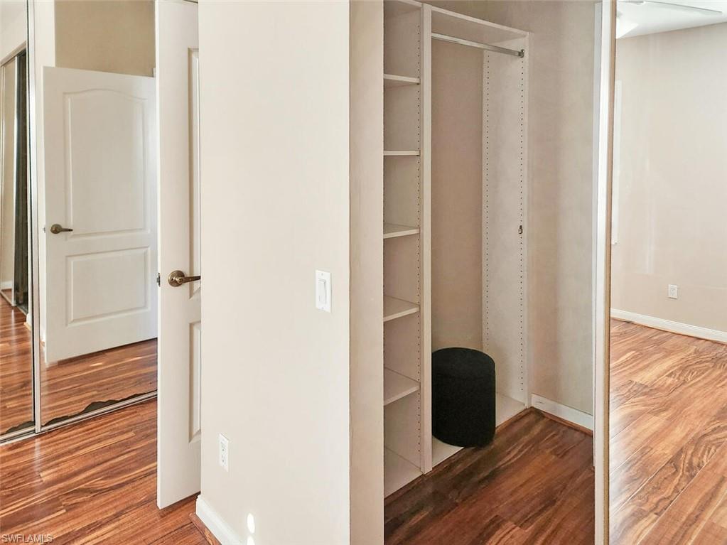 5417 Cove Circle, Unit 112 Naples, FL 34119 - Photo 21 of 37 a view of a hallway with wooden floor and closet