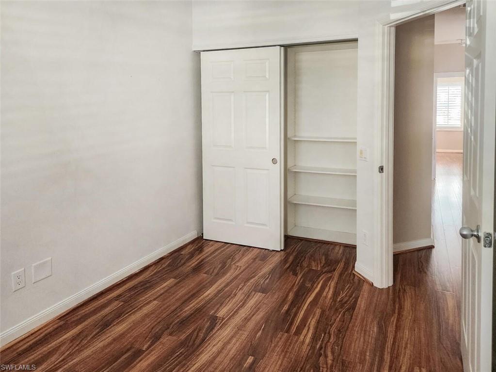 5417 Cove Circle, Unit 112 Naples, FL 34119 - Photo 23 of 37 a view of a room with wooden floor
