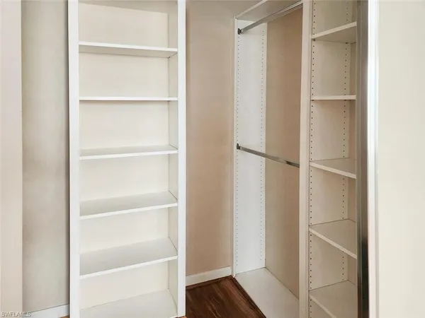 a view of walk in closet with empty racks