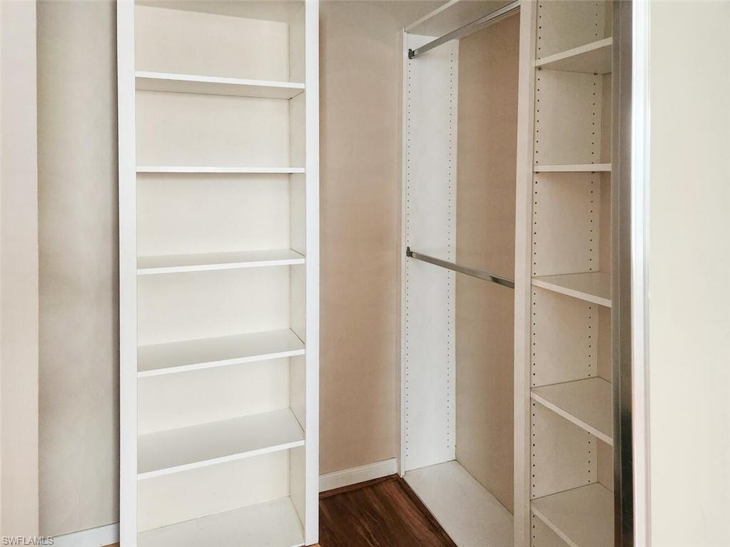 5417 Cove Circle, Unit 112 Naples, FL 34119 - Photo 24 of 37 a view of walk in closet with empty racks