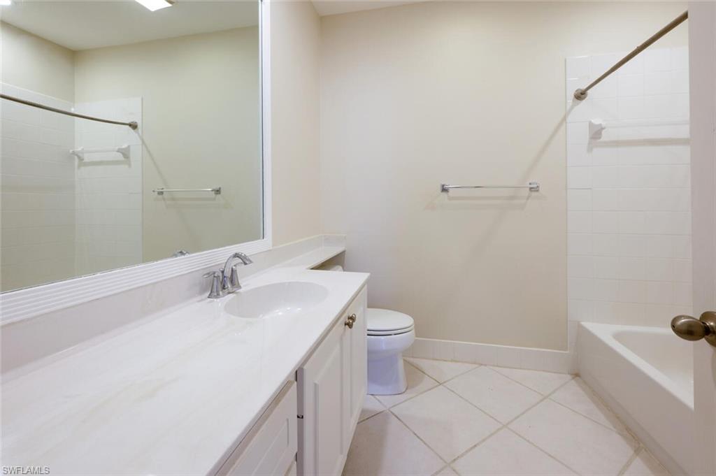 5417 Cove Circle, Unit 112 Naples, FL 34119 - Photo 26 of 37 a bathroom with a sink a toilet and shower