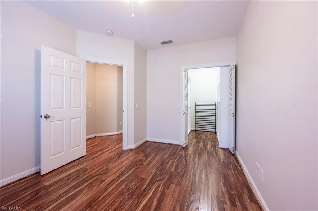 5417 Cove Circle, Unit 112 Naples, FL 34119 - Photo 28 of 37 a view of hallway with wooden floor