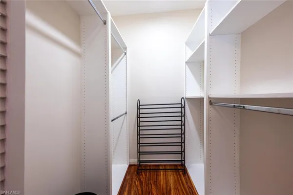 a view of a hallway with stairs and a closet