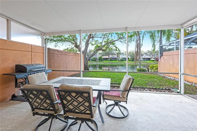 a table and chairs with the view of garden in the back
