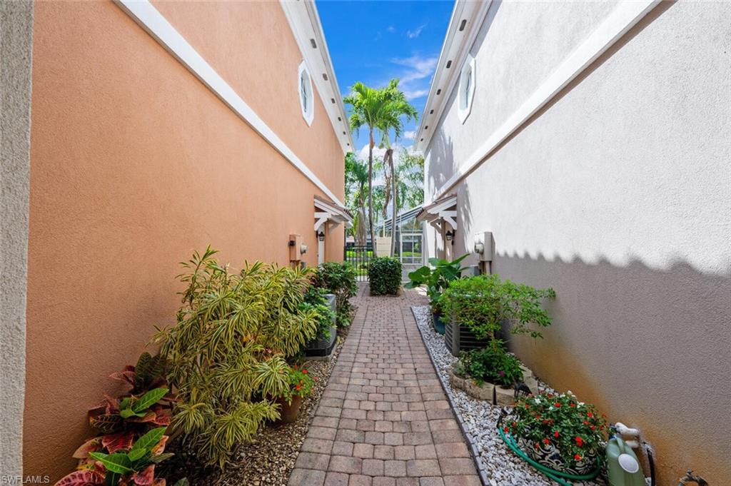 5417 Cove Circle, Unit 112 Naples, FL 34119 - Photo 3 of 37 a potted plant sitting in front of a window
