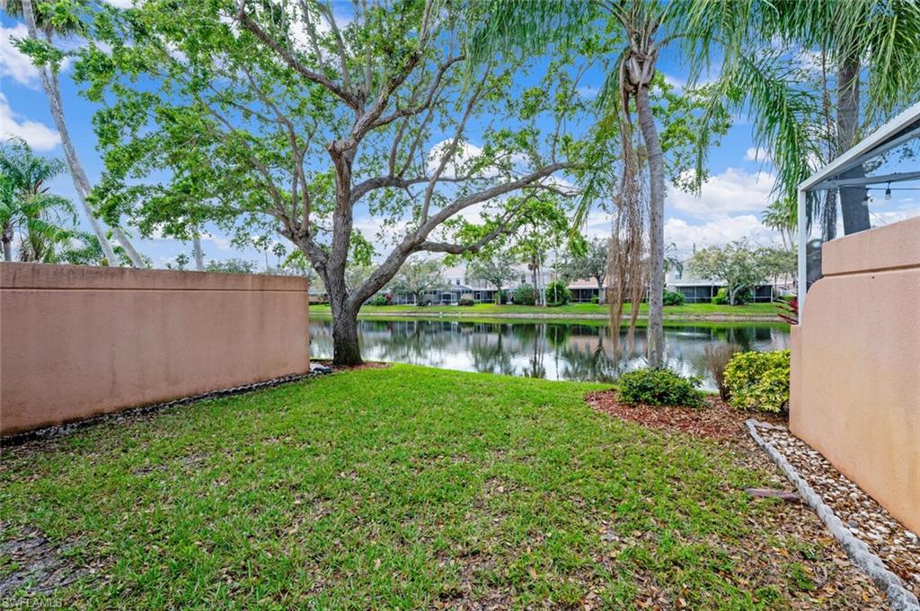 5417 Cove Circle, Unit 112 Naples, FL 34119 - Photo 32 of 37 a view of a garden with a tree