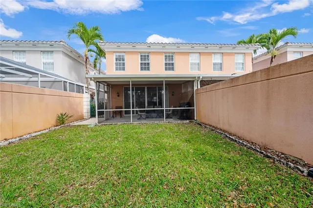 a view of an house with backyard space and balcony