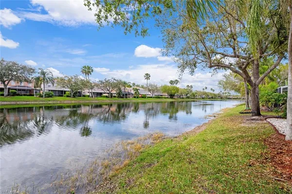 a view of a lake with houses in the back