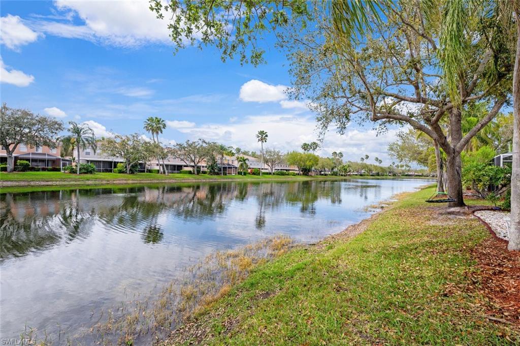 5417 Cove Circle, Unit 112 Naples, FL 34119 - Photo 35 of 37 a view of a lake with houses in the back