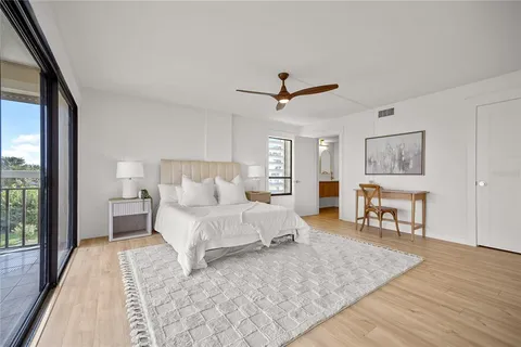 a bed room with a bed and a chandelier
