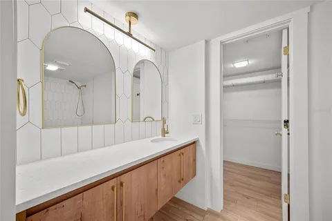 a bathroom with a double vanity sink and mirror