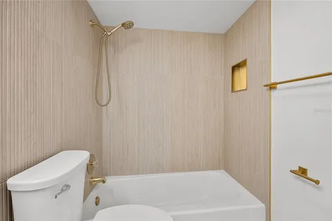 a bathroom with a shower a toilet and a shower