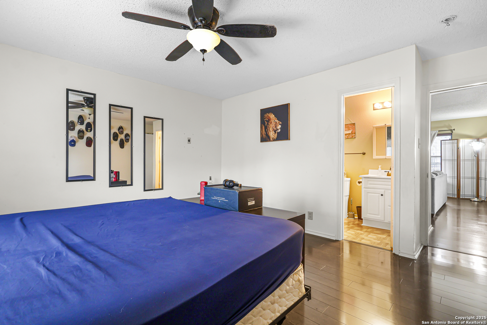 7234 Raintree Forest San Antonio, TX 78233 - Photo 13 of 23 a bedroom with a bed and wooden floor