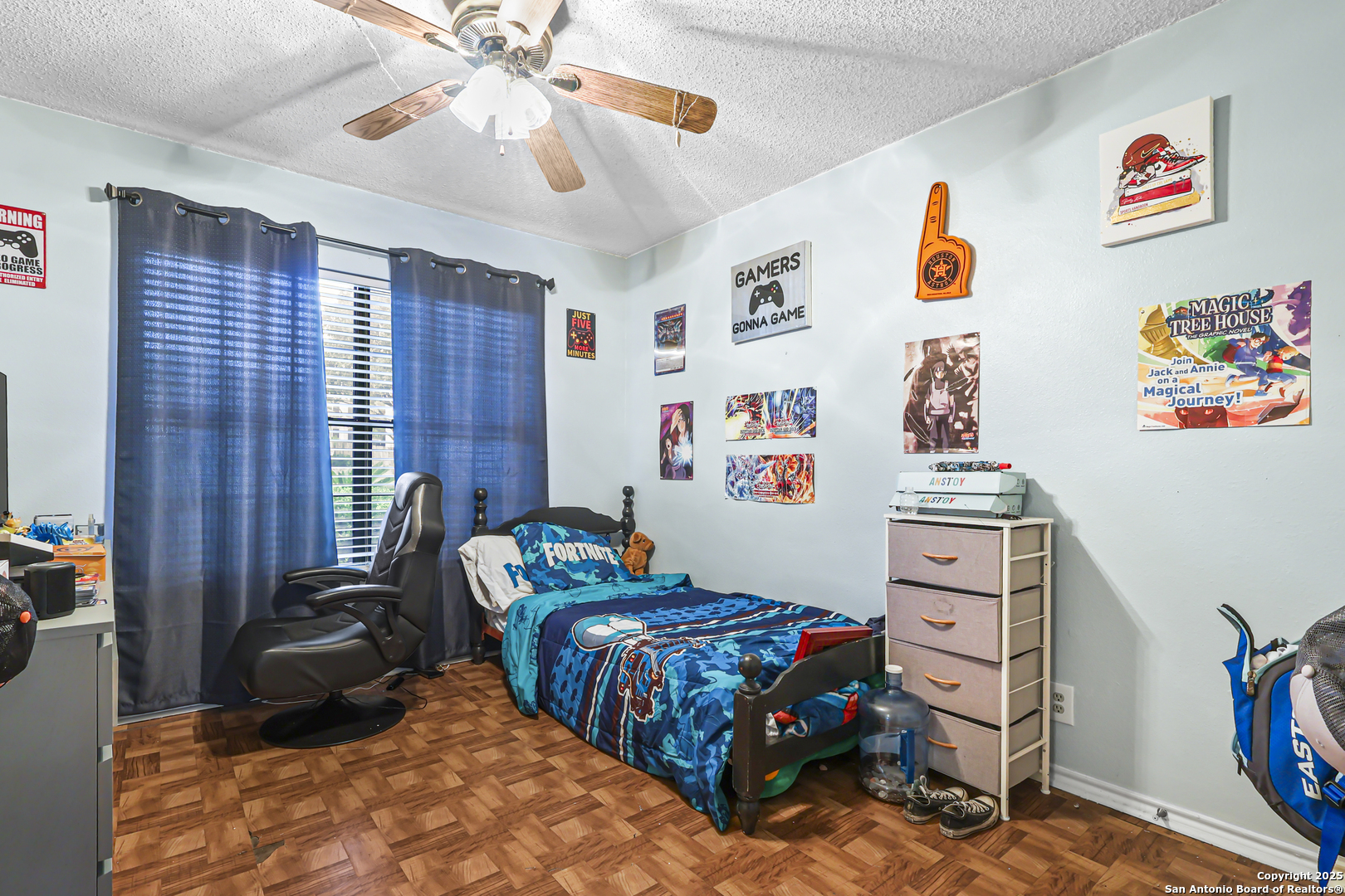 7234 Raintree Forest San Antonio, TX 78233 - Photo 15 of 23 a bedroom with a bed and a chandelier