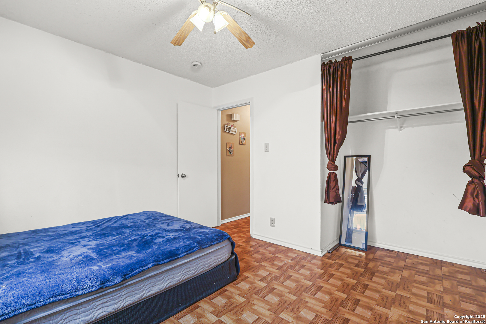 7234 Raintree Forest San Antonio, TX 78233 - Photo 19 of 23 a bedroom with a bed and a chandelier