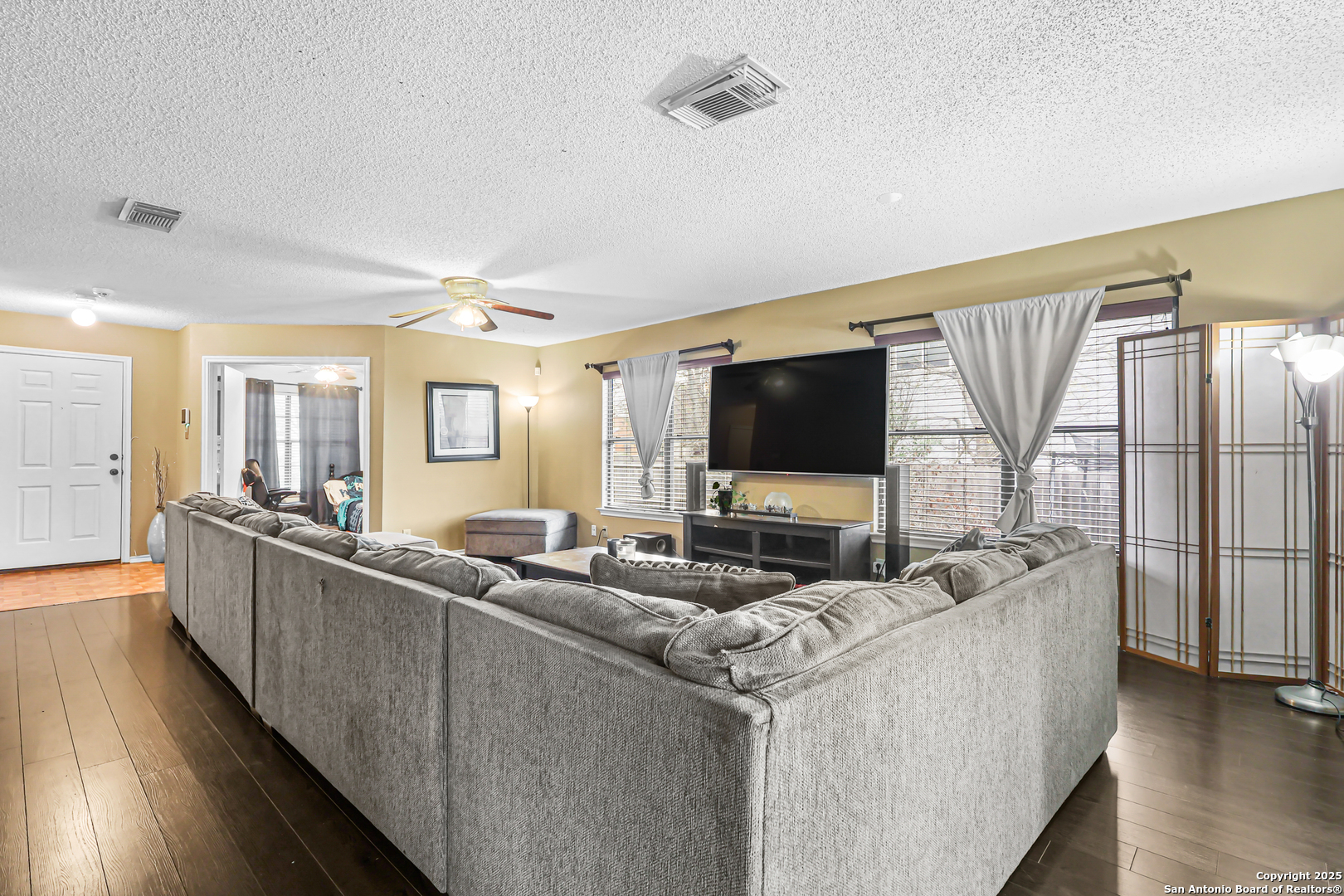 7234 Raintree Forest San Antonio, TX 78233 - Photo 4 of 23 a living room with furniture and a flat screen tv
