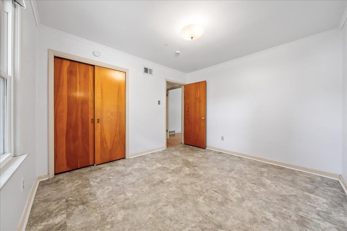 4841 Dee Road Memphis, TN 38117 - Photo 23 of 28 Unfurnished bedroom featuring ornamental molding and a closet