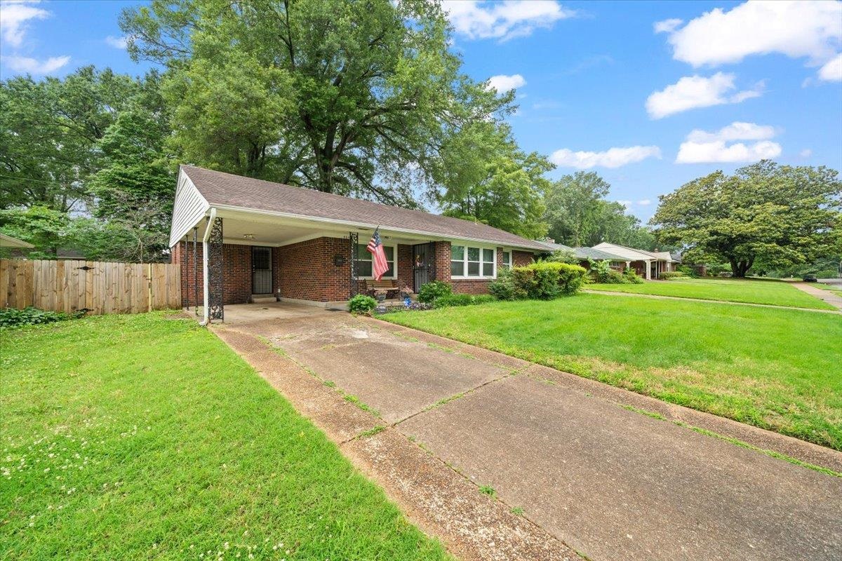 4841 Dee Road Memphis, TN 38117 - Photo 4 of 28 Ranch-style house featuring driveway, a carport, and brick siding